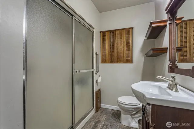 a bathroom with a sink toilet and shower