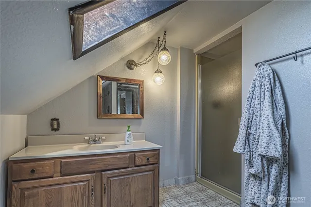 a bathroom with a toilet a sink and shower