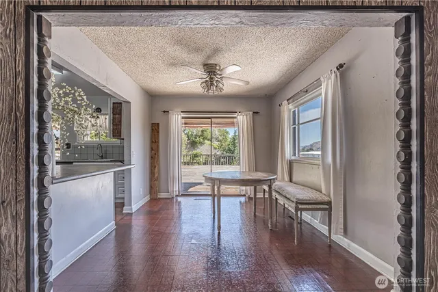 a view of a room with wooden floor and a window
