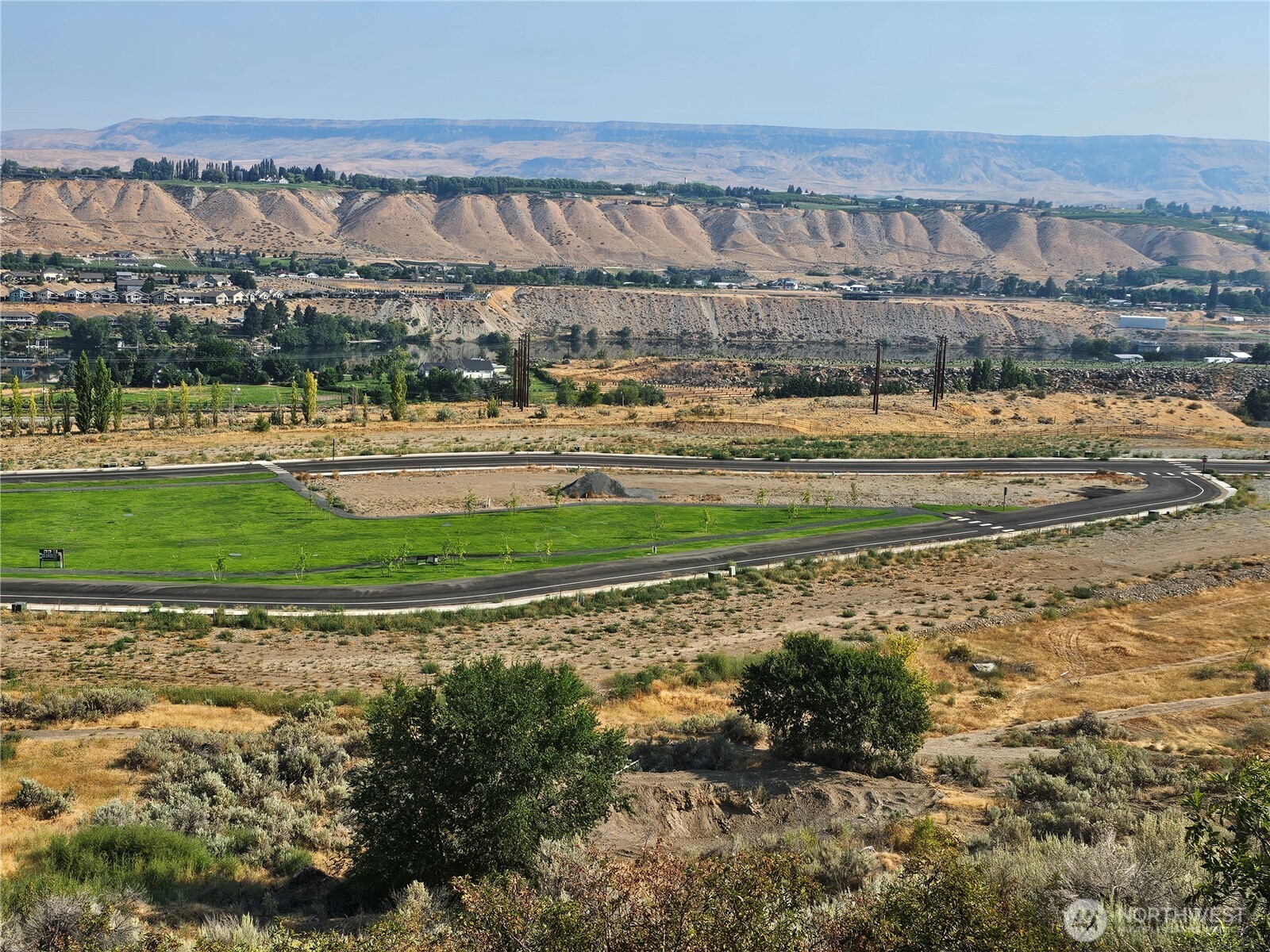 33 Riverview Lane Malaga, WA 98828 - Photo 6 of 9 a view of a big yard next to a building
