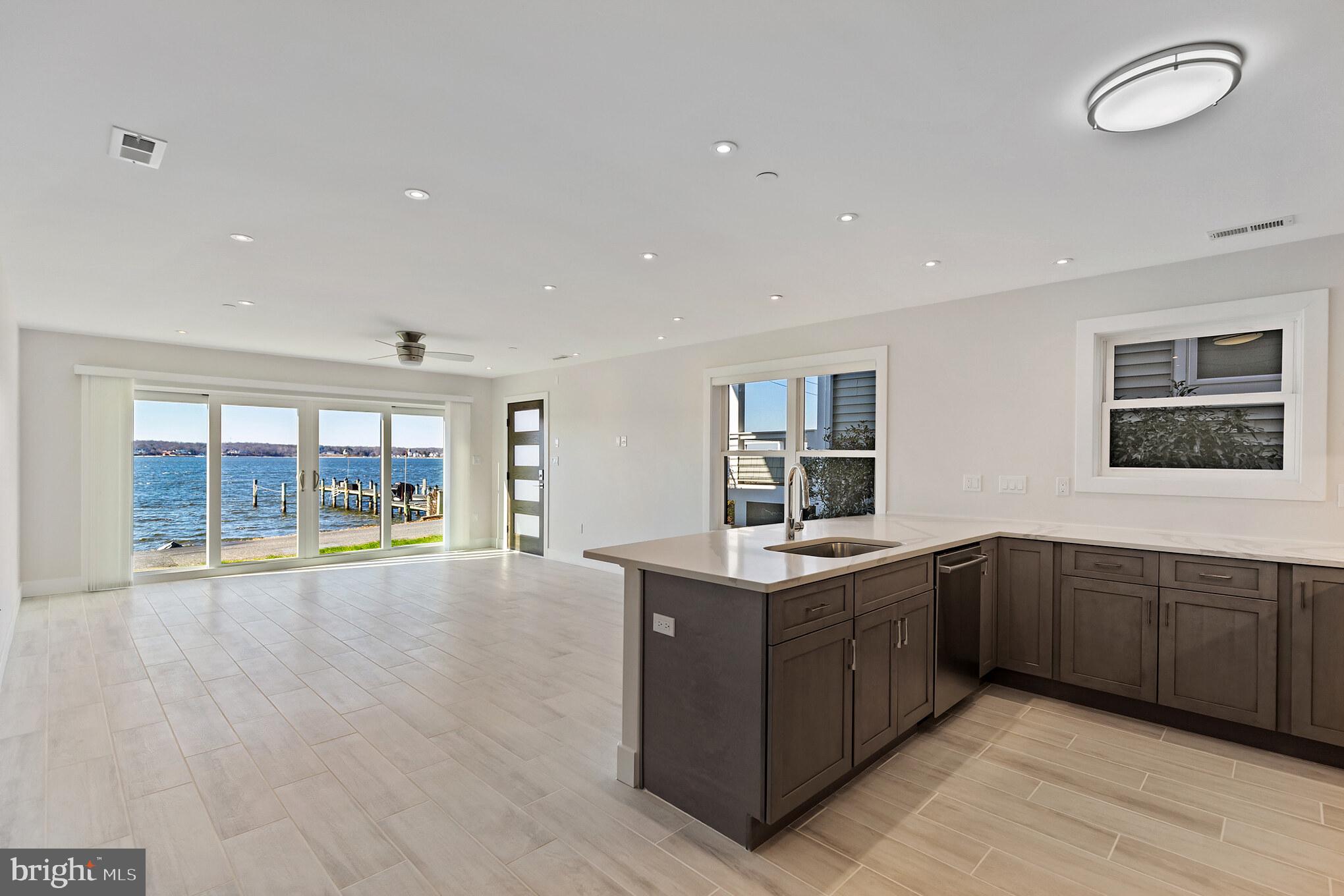 14732 Patuxent Avenue Solomons, MD 20688 - Photo 12 of 31 a large kitchen with stainless steel appliances granite countertop a large counter top and sink