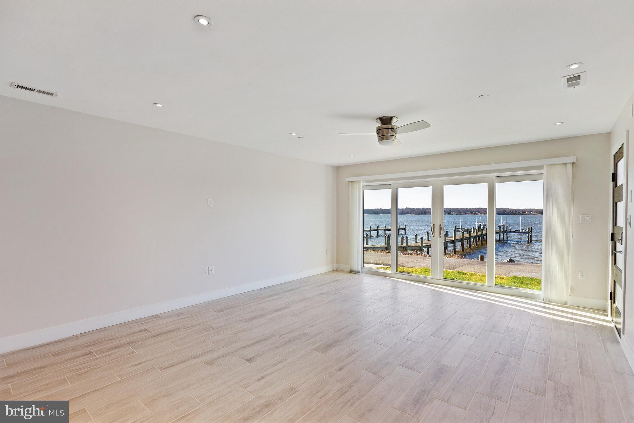14732 Patuxent Avenue Solomons, MD 20688 - Photo 13 of 31 wooden floor in an empty room with a window