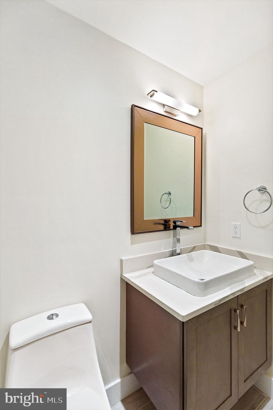 14732 Patuxent Avenue Solomons, MD 20688 - Photo 16 of 31 a bathroom with a sink and a mirror