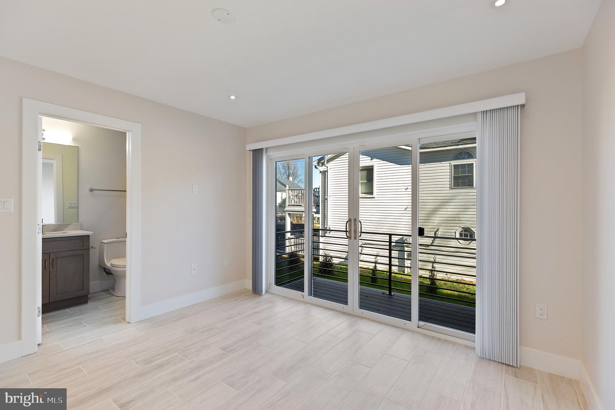 14732 Patuxent Avenue Solomons, MD 20688 - Photo 19 of 31 a view of empty room with wooden floor and fan