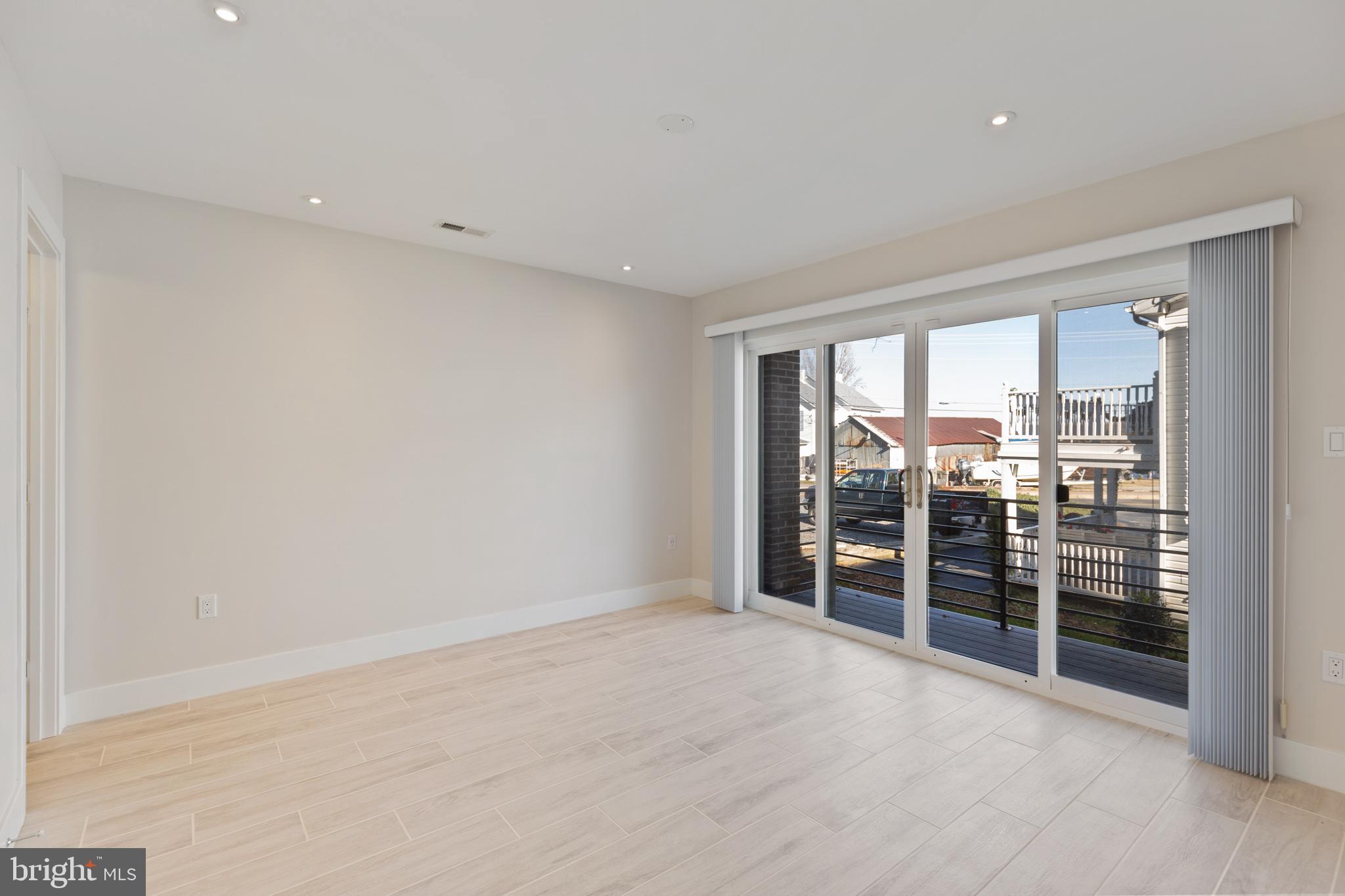 14732 Patuxent Avenue Solomons, MD 20688 - Photo 24 of 31 wooden floor in an empty room with a window