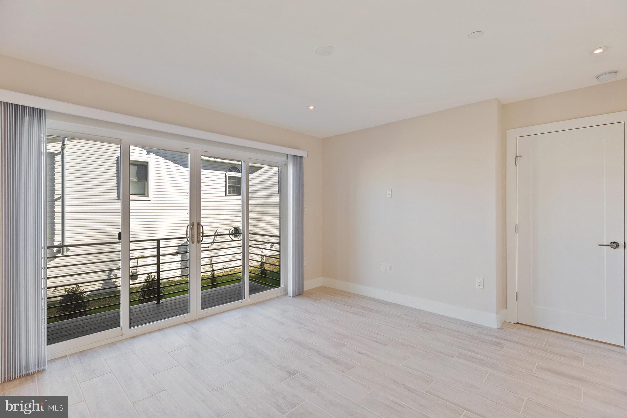 14732 Patuxent Avenue Solomons, MD 20688 - Photo 25 of 31 wooden floor in an empty room with windows