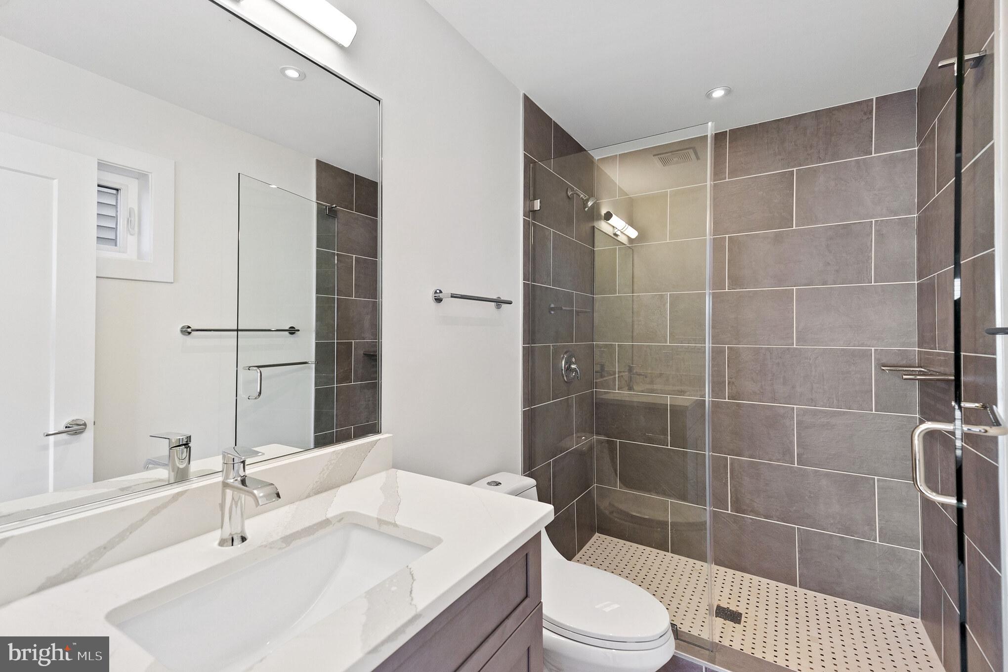 14732 Patuxent Avenue Solomons, MD 20688 - Photo 27 of 31 a bathroom with a sink a toilet and shower