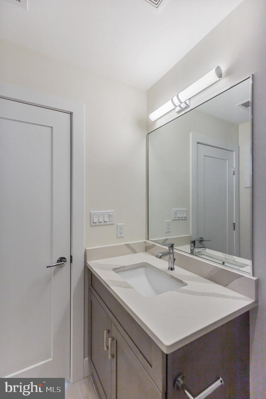 14732 Patuxent Avenue Solomons, MD 20688 - Photo 28 of 31 a bathroom with a sink and a mirror