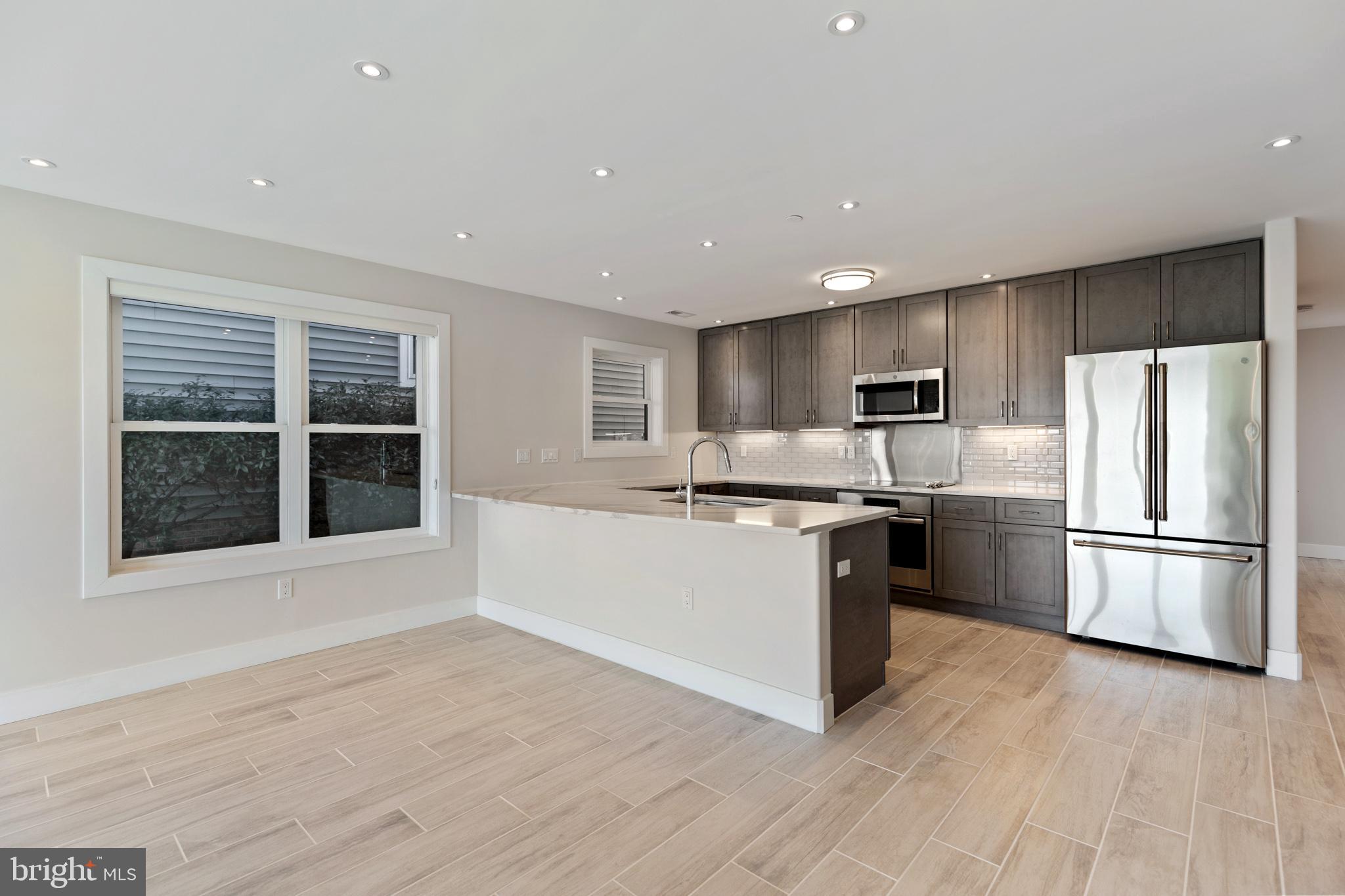 14732 Patuxent Avenue Solomons, MD 20688 - Photo 7 of 31 a kitchen with a refrigerator and a stove top oven