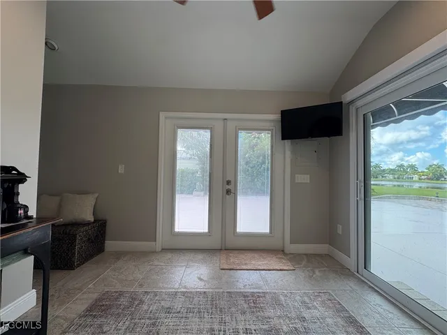 a view of an empty room with a window and bathroom