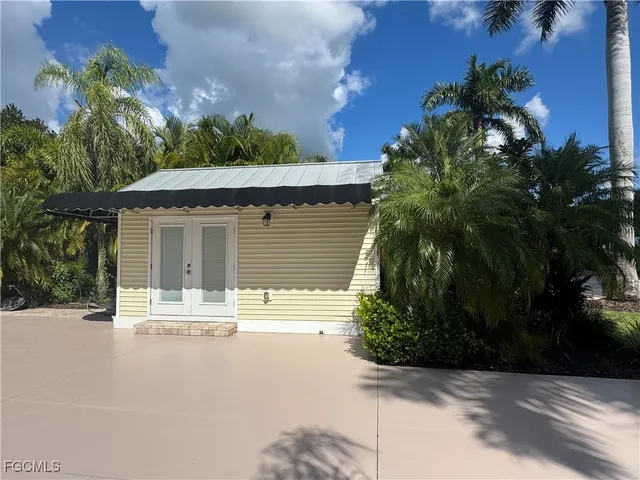 a house with palm tree in front of it