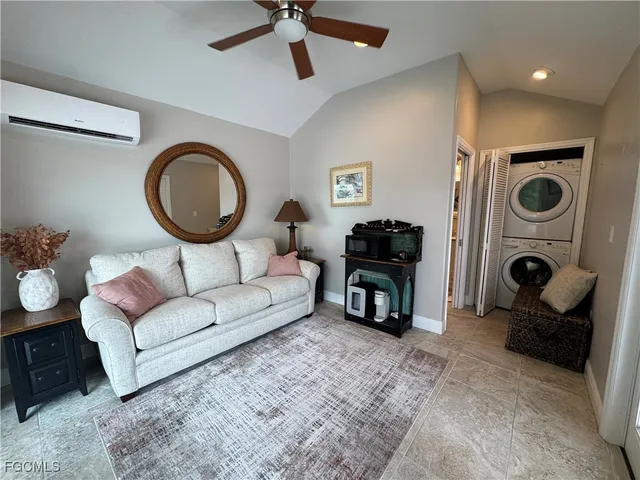 a living room with furniture a clock and a fireplace