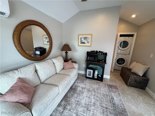 a living room with furniture and a mirror