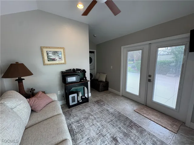 a living room with furniture and a lamp
