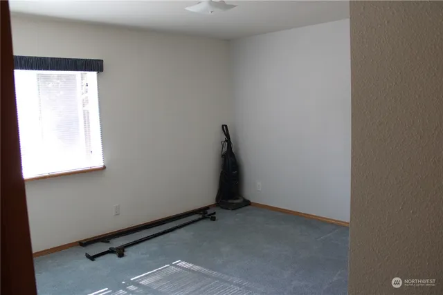 an empty room with windows and closet