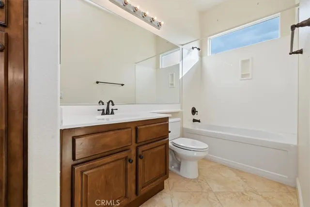 a view of a kitchen with a sink and a refrigerator