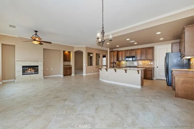 a kitchen with stainless steel appliances granite countertop a sink a stove and a refrigerator