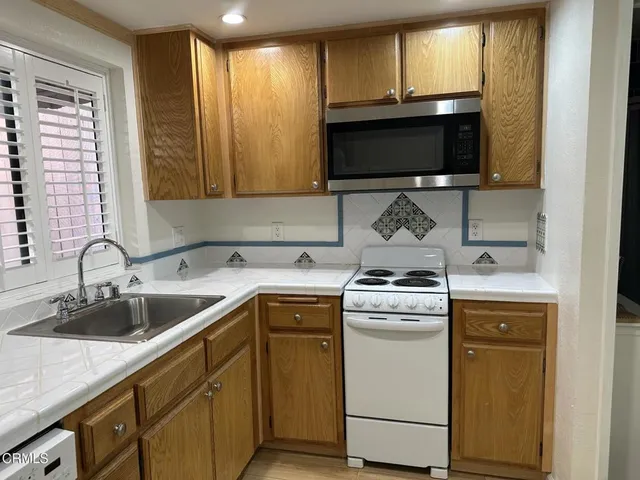 a kitchen with a stove and a sink