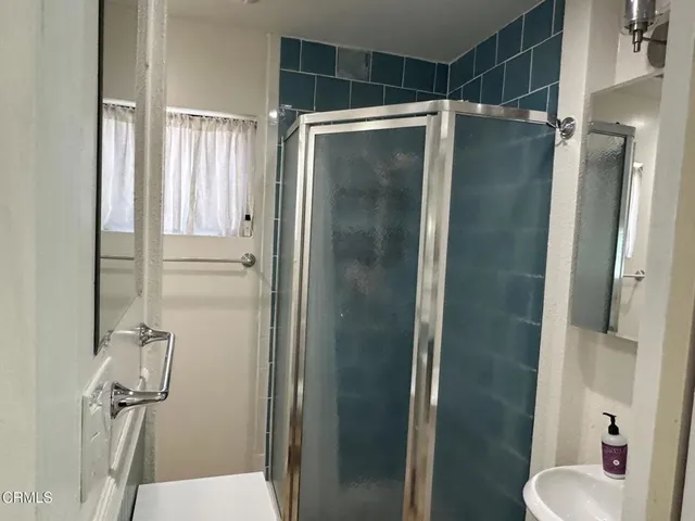 a bathroom with a shower and a mirror