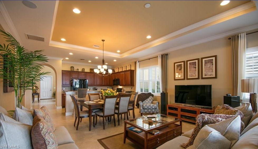 13644 Manchester Lane Naples, FL 34109 - Photo 12 of 18 a living room with furniture kitchen view and a flat screen tv