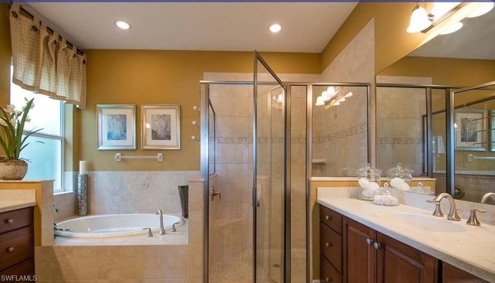 13644 Manchester Lane Naples, FL 34109 - Photo 15 of 18 a bathroom with a granite countertop sink a toilet and shower