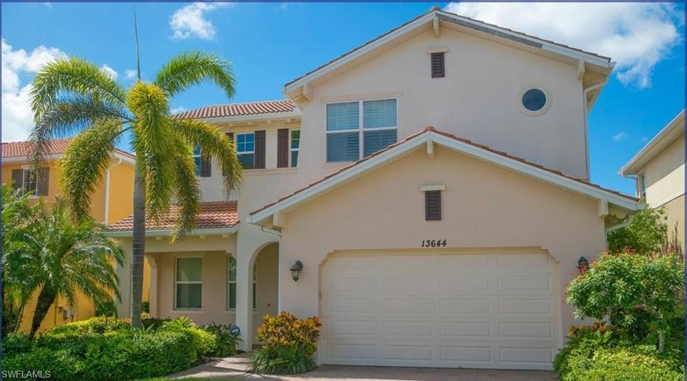 13644 Manchester Lane Naples, FL 34109 - Photo 2 of 18 a front view of a house with a yard