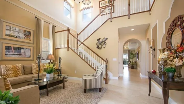 a living room with furniture and large windows