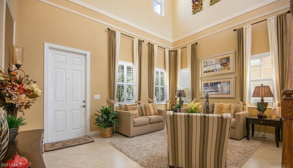 13644 Manchester Lane Naples, FL 34109 - Photo 7 of 18 a living room with furniture and large windows