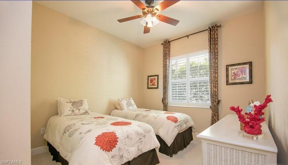 13644 Manchester Lane Naples, FL 34109 - Photo 9 of 18 a bedroom with a bed and a chandelier