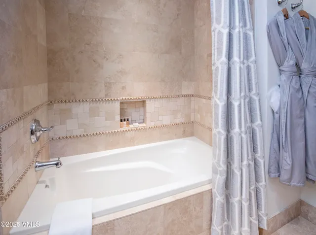 a bathroom with a bathtub and shower