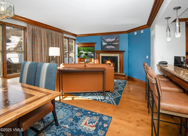 a living room with kitchen island furniture and a fireplace
