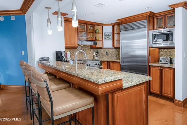 a dining table with chairs and chandelier