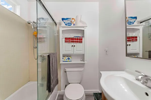 a bathroom with a toilet a sink and a shower