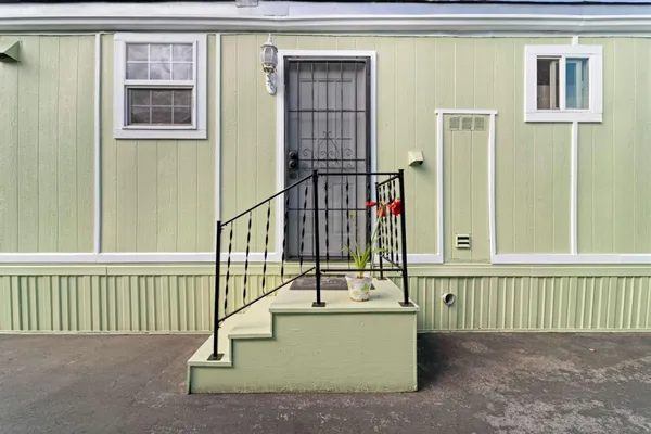 a view of staircase and small kitchen