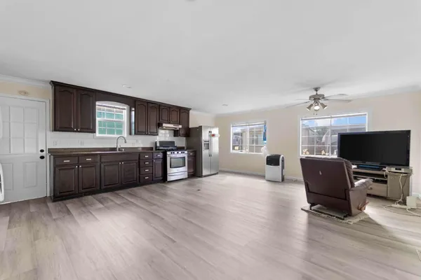 a living room with hard wood floors and furniture