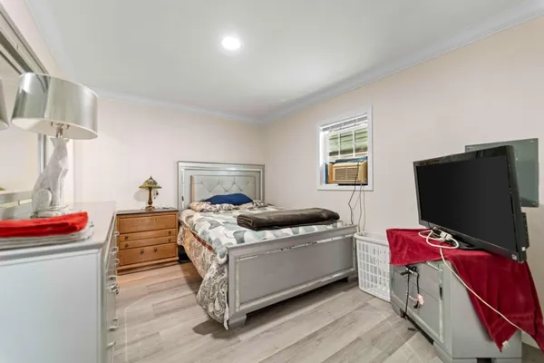 a bedroom with a bed and flat screen tv