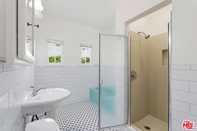 an empty room with windows and ceiling fan