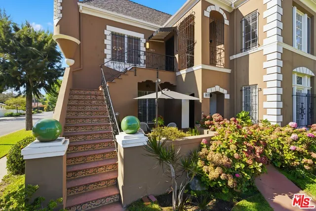 an empty room with windows and chandelier