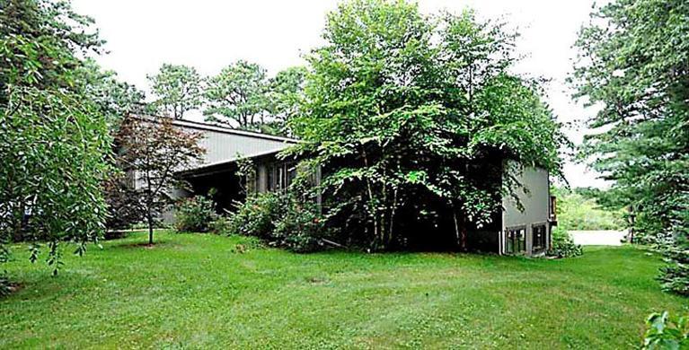 580 Lumbert Mill Road Centerville, MA 02632 - Photo 3 of 34 a view of a backyard with potted plants and large trees