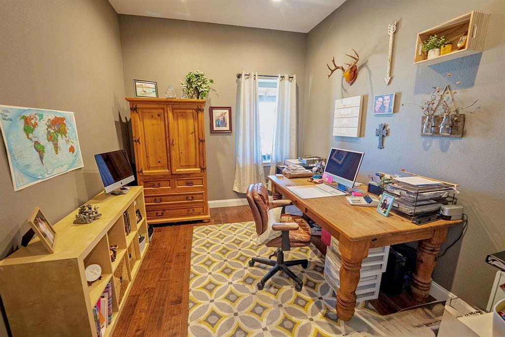 290 Barton Road Maypearl, TX 76064 - Photo 12 of 32 a view of a workspace with furniture and a living room