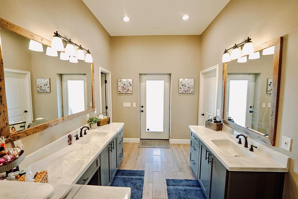290 Barton Road Maypearl, TX 76064 - Photo 12 of 34 a spacious bathroom with a double vanity sink mirror and double