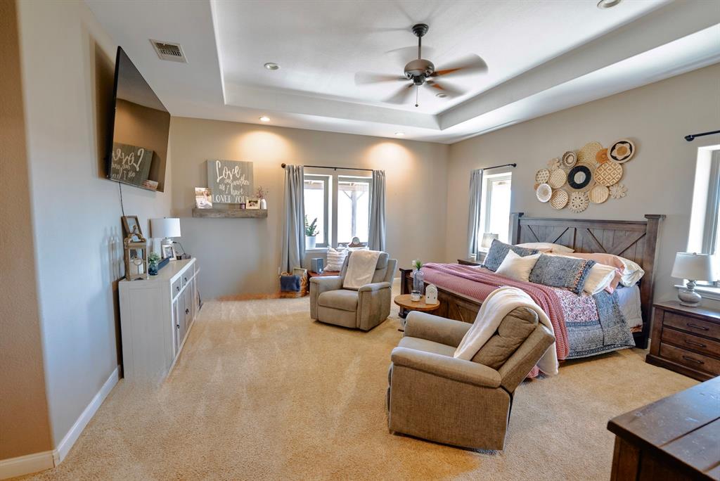 290 Barton Road Maypearl, TX 76064 - Photo 13 of 32 a bedroom with furniture and a flat screen tv