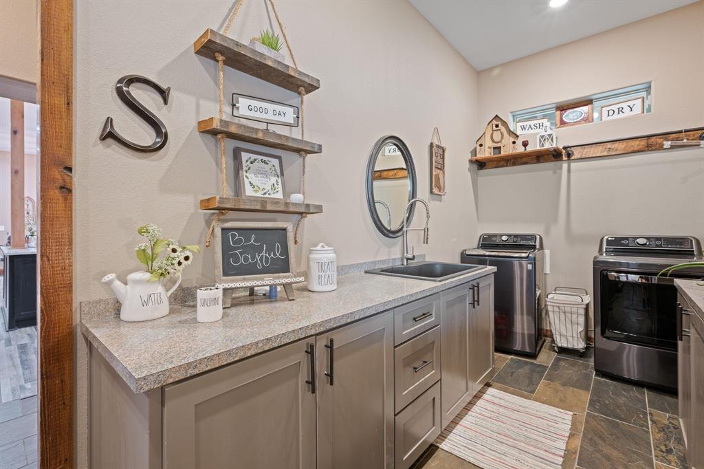 290 Barton Road Maypearl, TX 76064 - Photo 15 of 34 a kitchen with a sink and a stove top oven