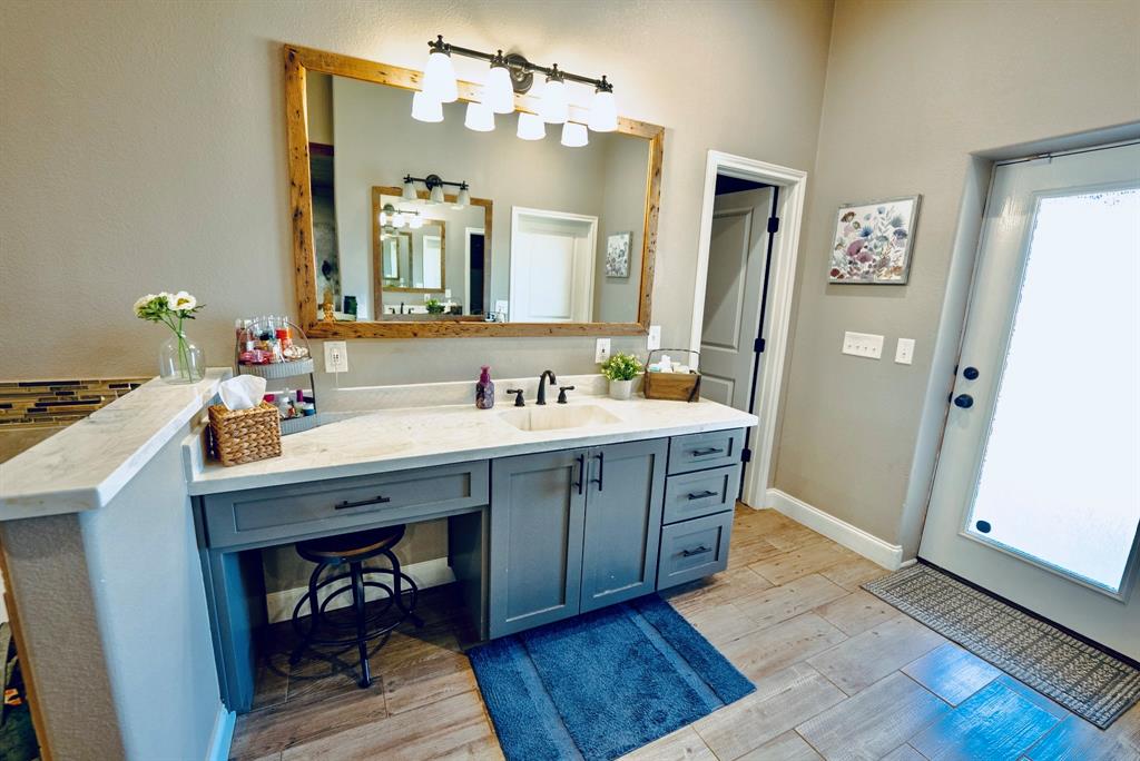 290 Barton Road Maypearl, TX 76064 - Photo 15 of 32 a spacious bathroom with a double vanity sink and a mirror