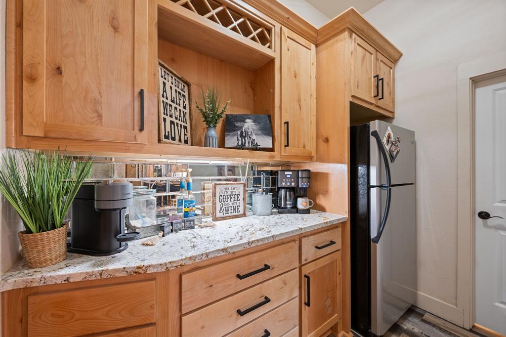 290 Barton Road Maypearl, TX 76064 - Photo 16 of 34 a kitchen with stainless steel appliances granite countertop a refrigerator and a sink