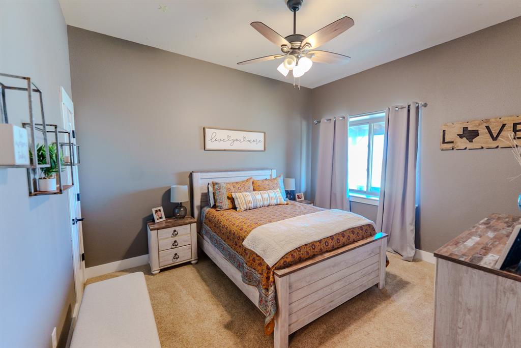 290 Barton Road Maypearl, TX 76064 - Photo 17 of 32 a bedroom with a bed chandelier and a window