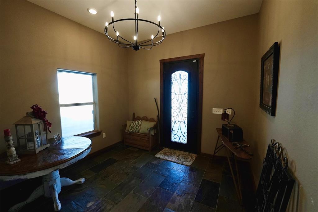 290 Barton Road Maypearl, TX 76064 - Photo 4 of 32 a view of a livingroom with furniture hardwood floor and a chandelier