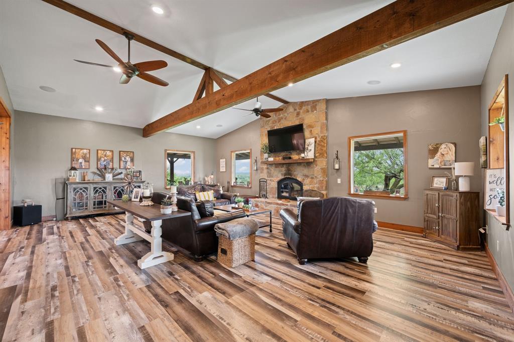 290 Barton Road Maypearl, TX 76064 - Photo 4 of 34 a living room with furniture a fireplace and a flat screen tv