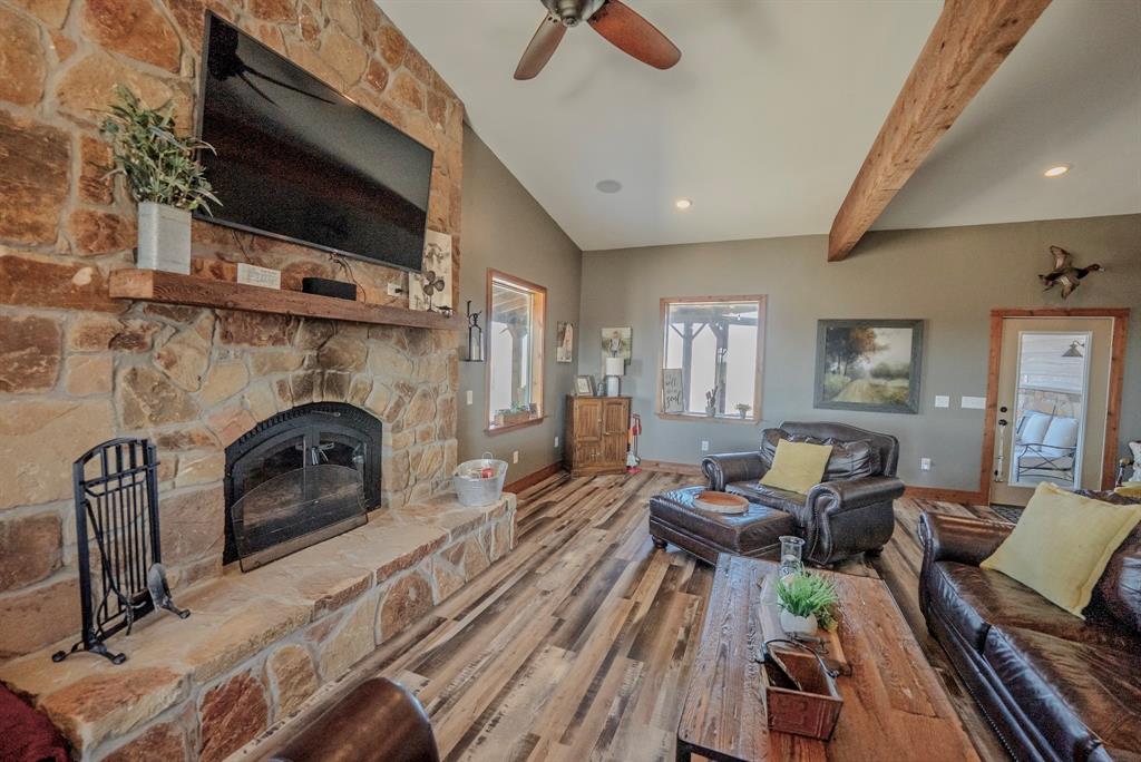 290 Barton Road Maypearl, TX 76064 - Photo 5 of 32 a living room with furniture a fireplace and a flat screen tv