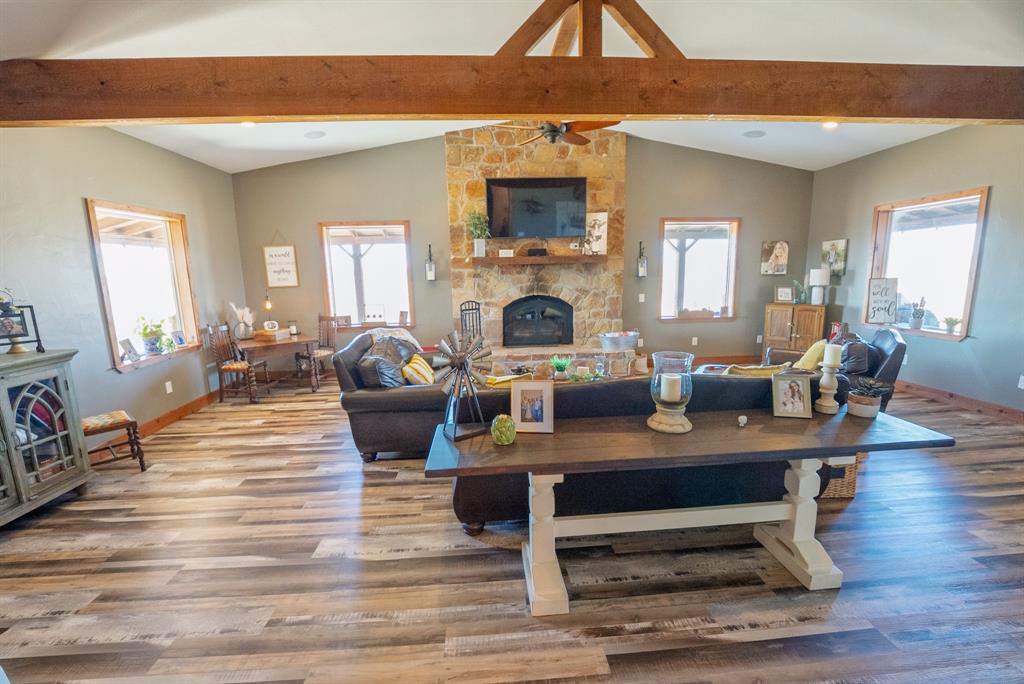 290 Barton Road Maypearl, TX 76064 - Photo 7 of 32 a living room with furniture a fireplace and a flat screen tv
